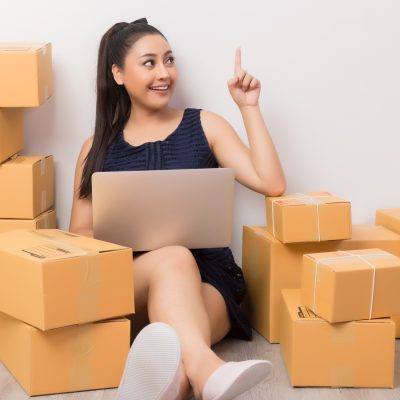 business owner working at home office packaging on background